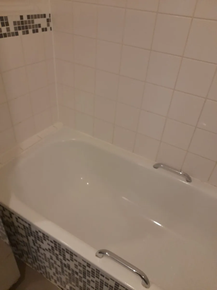 Bathtub and tile walls scrubbed bright
