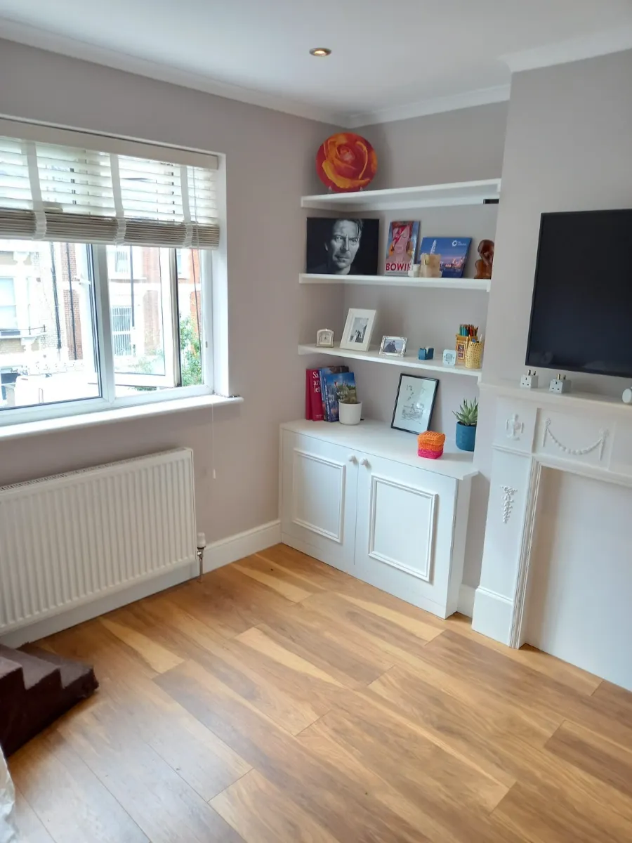 Living room shelves dusted and wood floors polished